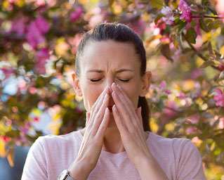 woman sneezing allergies
